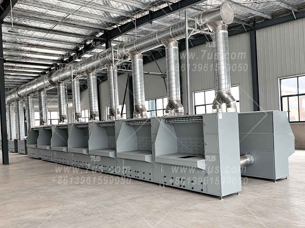 A row of enclosed workbenches connected to a common overhead extraction duct