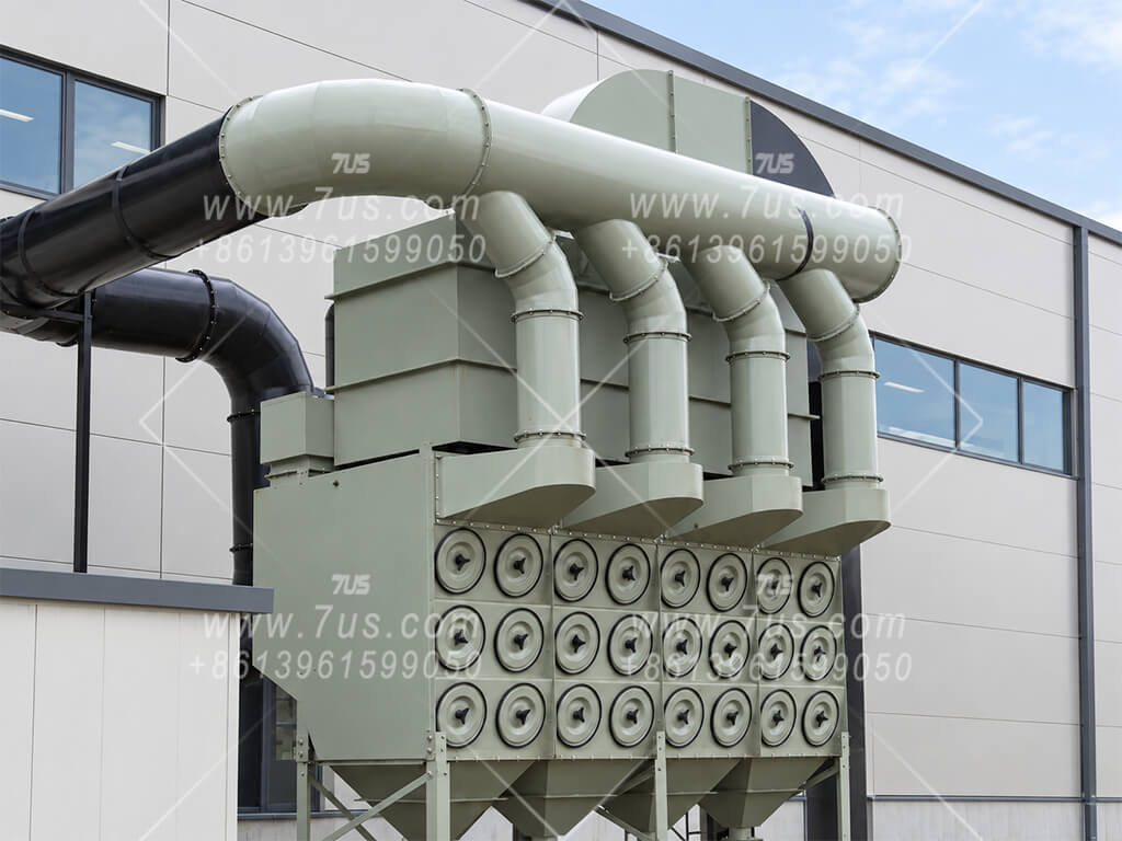 Four downflow cartridge collector modules with one shared HEPA housing mounted across the top