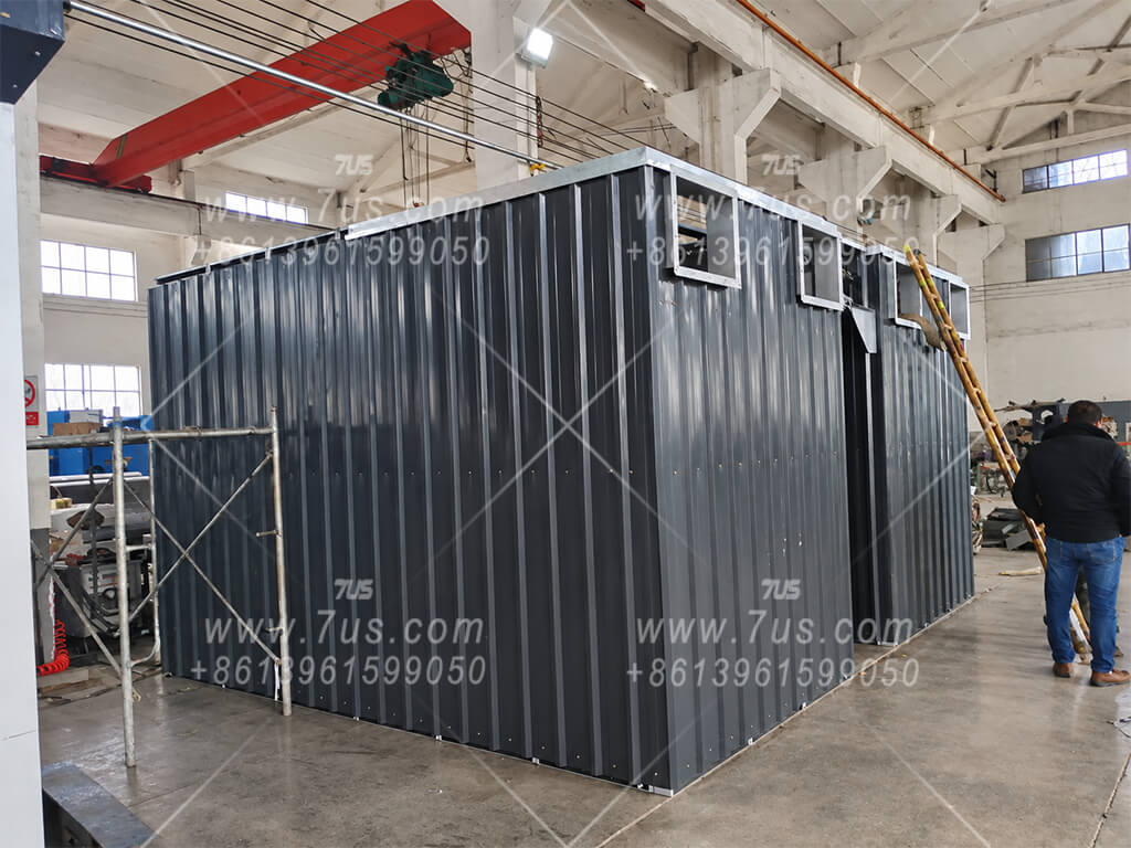 Upper baghouse housing with installed dark corrugated exterior cladding