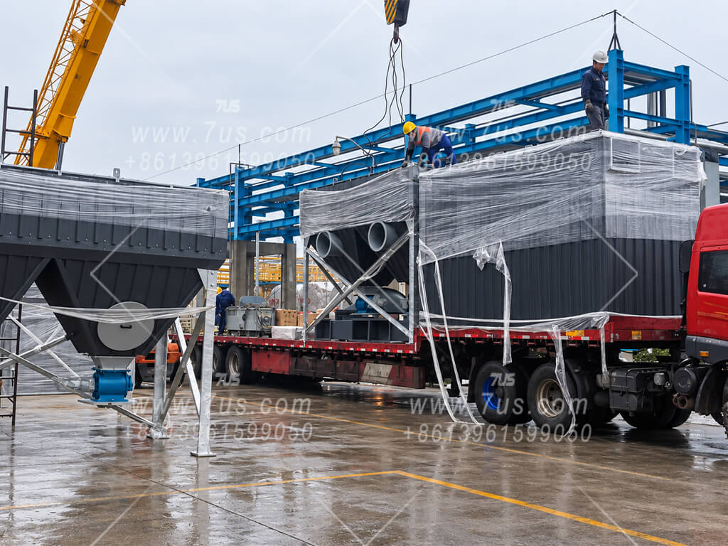 Wrapped baghouse sections being loaded on a truck