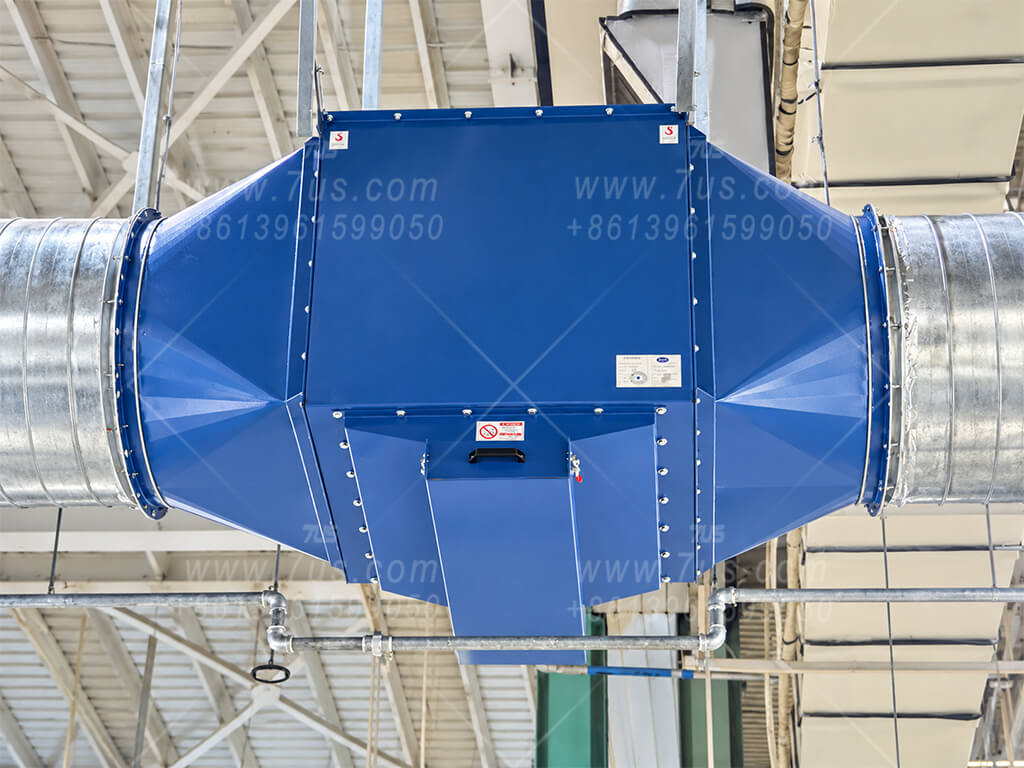 Blue baffle spark arrestor installed horizontally in silver extraction ductwork