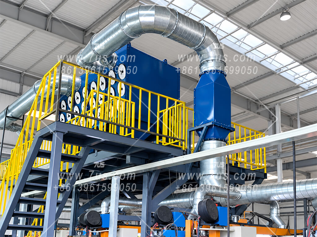 Vertical blue spark arrestor next to a cartridge dust collector on a steel platform