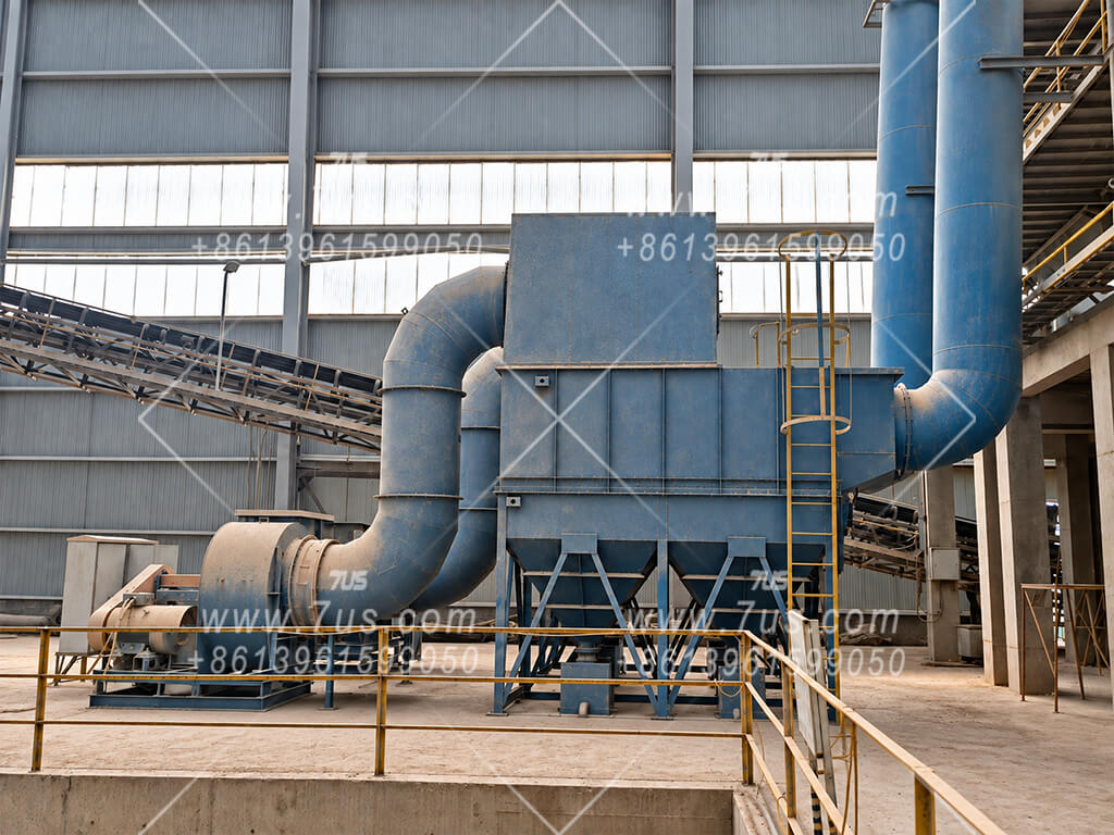 D-type wet dust collector with lower hoppers, an extraction fan and ductwork at a mineral crushing installation