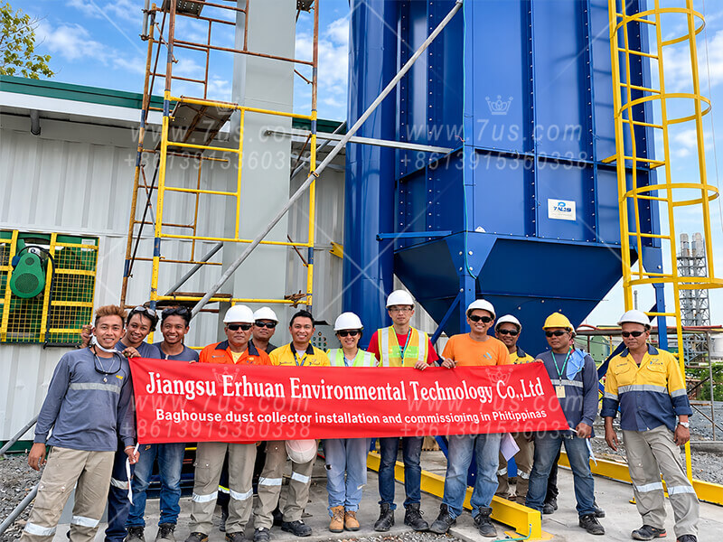Dust collection project team beside an installed baghouse